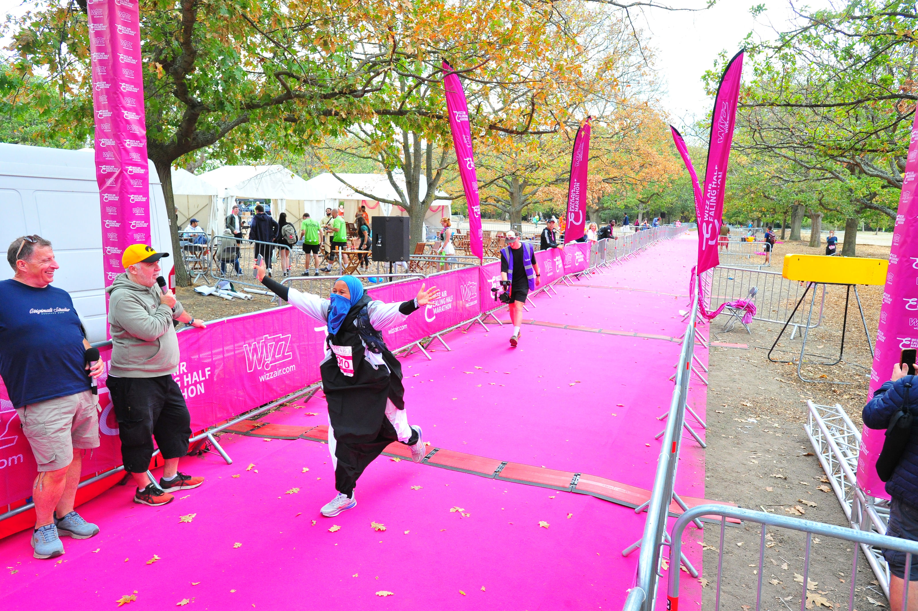 Runner crossing the finish line beneath a FINISH banner